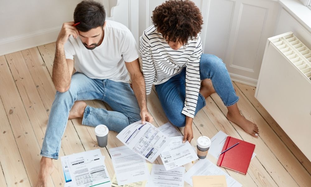 Una coppia che cerca tra i documenti, per Asimmetria informativa che creano dubbi